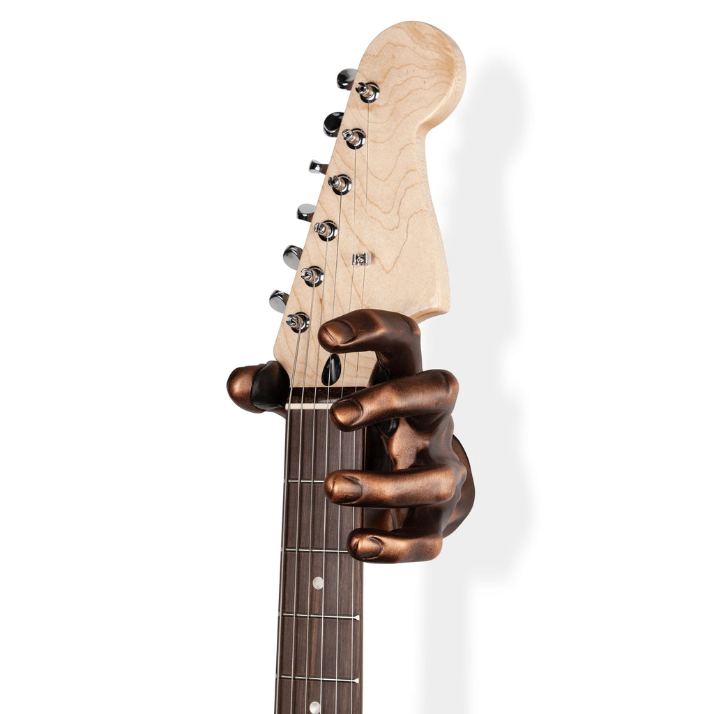 copper hand guitar mount holding guitar.
