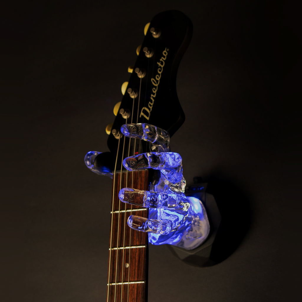 LED Guitar Hanger for wall hanging instrument. Design by GuitarGrip and Made in the USA. Blue Lights in crystal clear hand on black background.