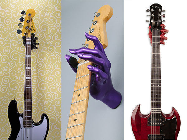 Three guitar hangers on the wall holding a Fender bass and Epiphone guitars. Gift Ideas for guitar lovers.