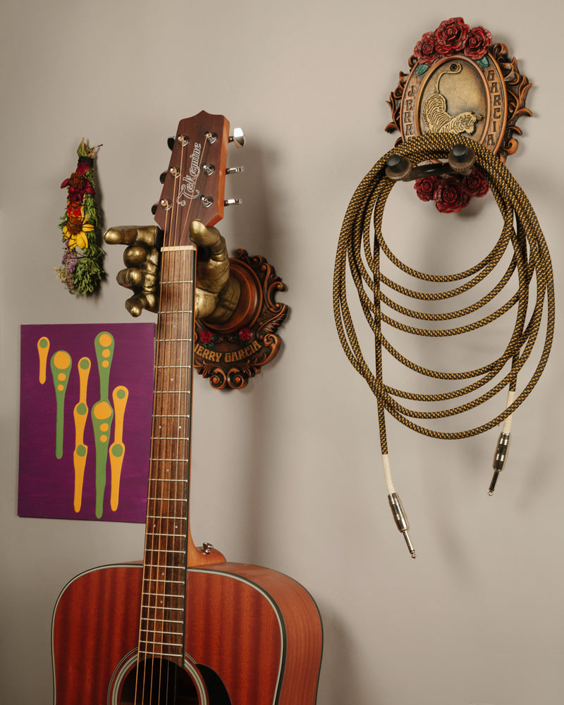 Grateful Dead and Jerry Garcia wall hangers for guitar and other items. In woodtone finish with Tiger logo and Rose Backplate. Holds acoustic guitars and electric guitar chords. 