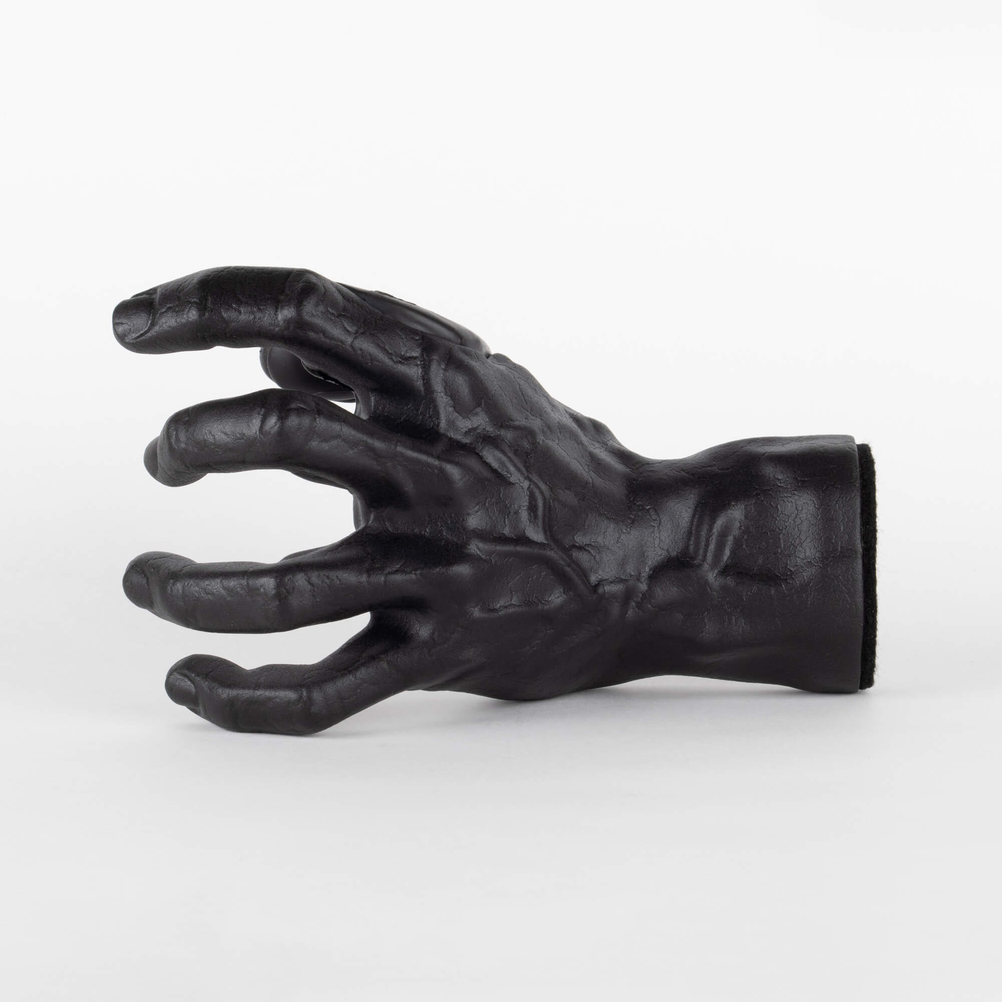 Black finish guitar hook for wall display in the shape of a hand. 