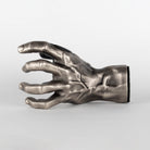 Outside view of male silver hand guitar holder to display instruments on the wall. 