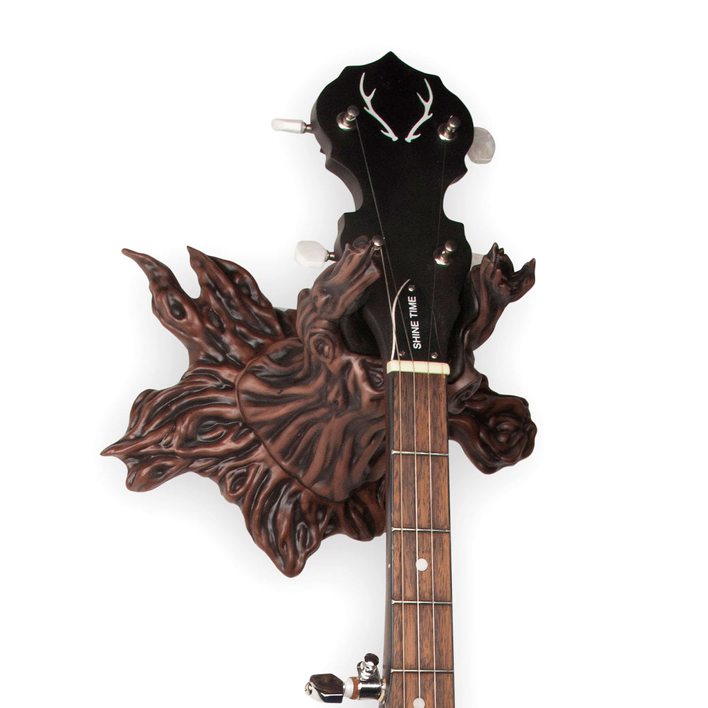 tree stump guitar wall mount holding banjo. 
