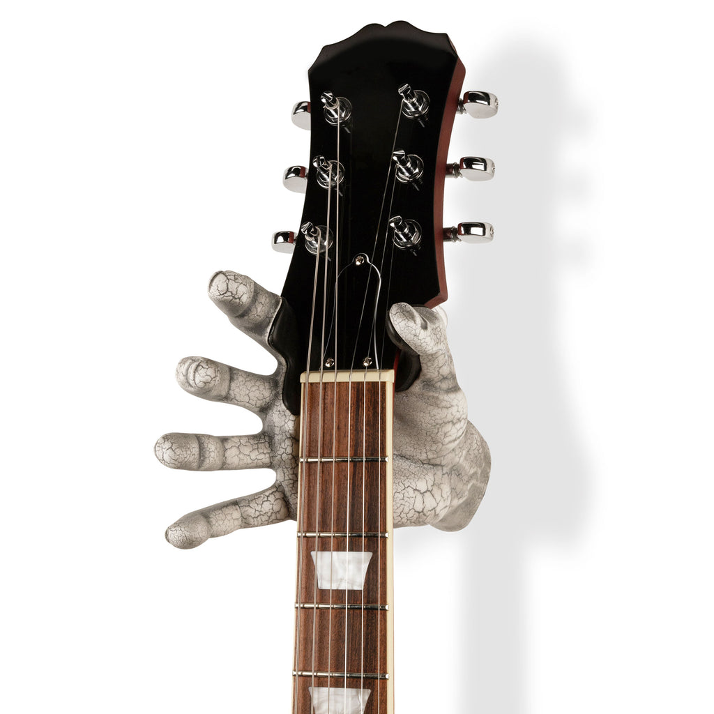 sculpted hand holding guitar to wall. White crackle finish. 